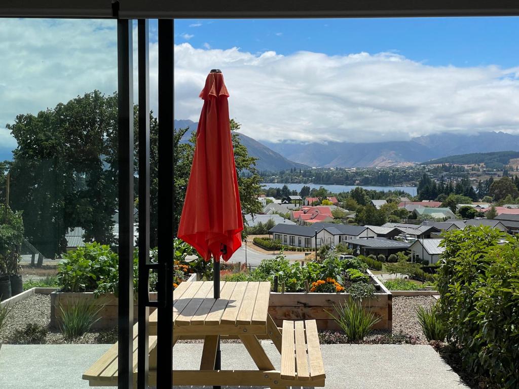 a red umbrella sitting on top of a table at Lake Views - new apartment with room to relax in Wanaka