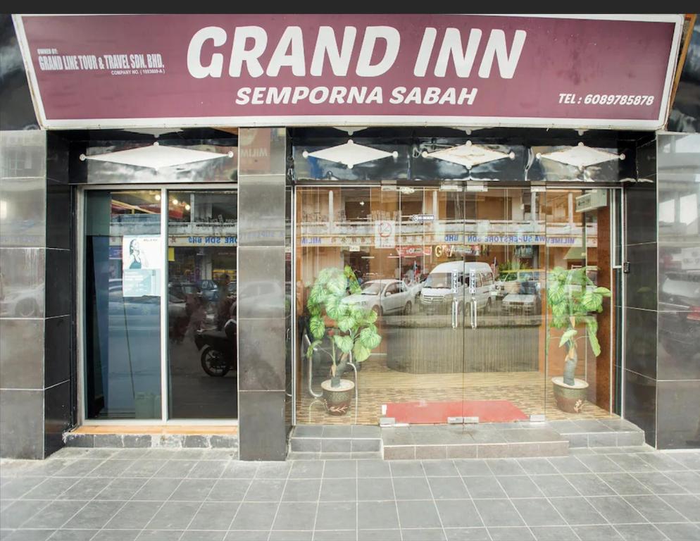 a grand mtn store with potted plants in the window at Grand Inn Hotel Semporna in Semporna