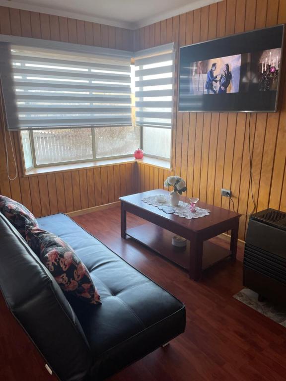 a living room with a couch and a coffee table at Cabañas Porvenir Tierra del Fuego in Porvenir