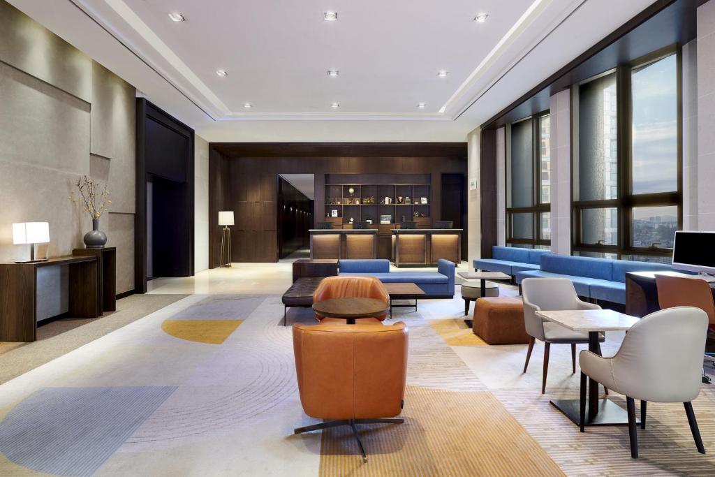 a lobby of a hotel with couches and chairs at Four Points by Sheraton Josun, Seoul Station in Seoul