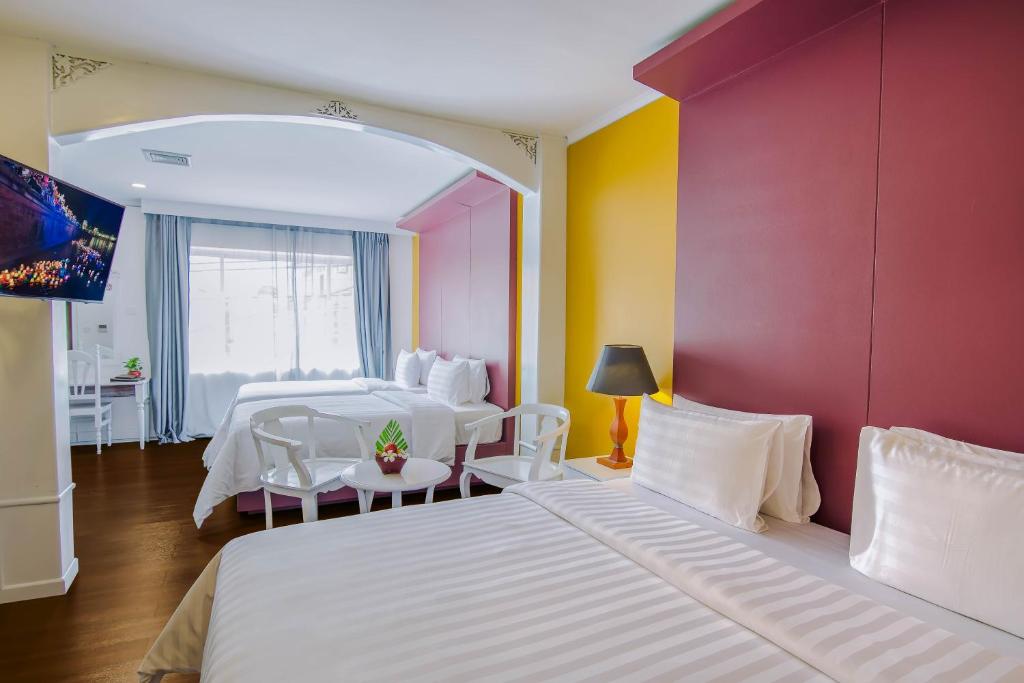 Postel nebo postele na pokoji v ubytování Memoire Siem Reap Hotel