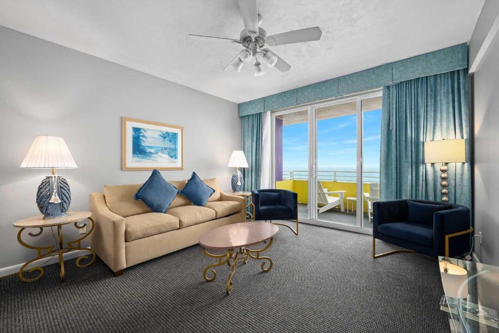 a living room with a couch and a view of the ocean at Luxury 6th Floor 1 BR Condo Direct Oceanfront Wyndham Ocean Walk Resort Daytona Beach | 610 in Daytona Beach