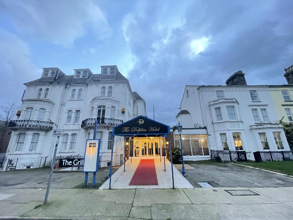 a large white building with a red carpet in front of it at The Dolphin Hotel in Great Yarmouth