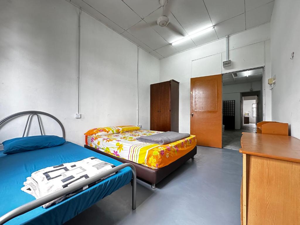 Voodi või voodid majutusasutuse Jiaxin Dormitory - Puteri Wangsa 家馨旅舍 toas