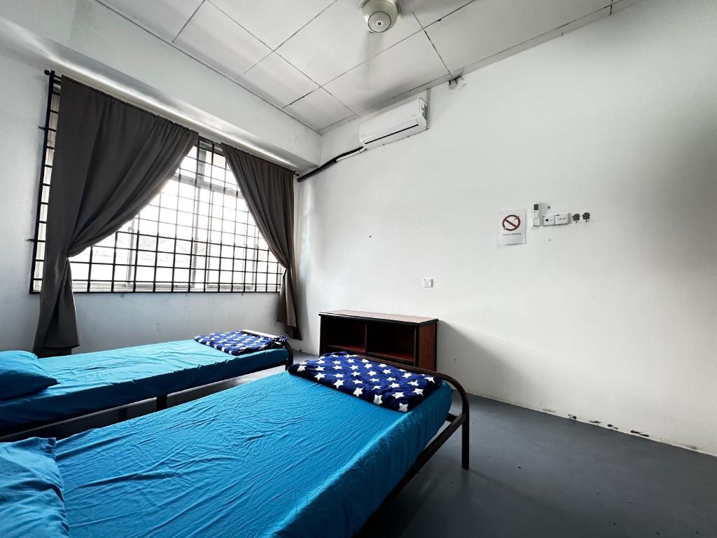 Voodi või voodid majutusasutuse Jiaxin Dormitory - Puteri Wangsa 家馨旅舍 toas
