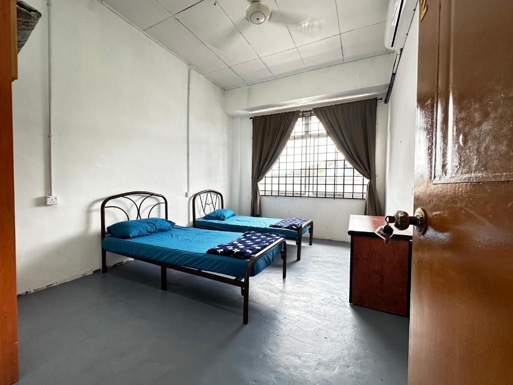 Voodi või voodid majutusasutuse Jiaxin Dormitory - Puteri Wangsa 家馨旅舍 toas