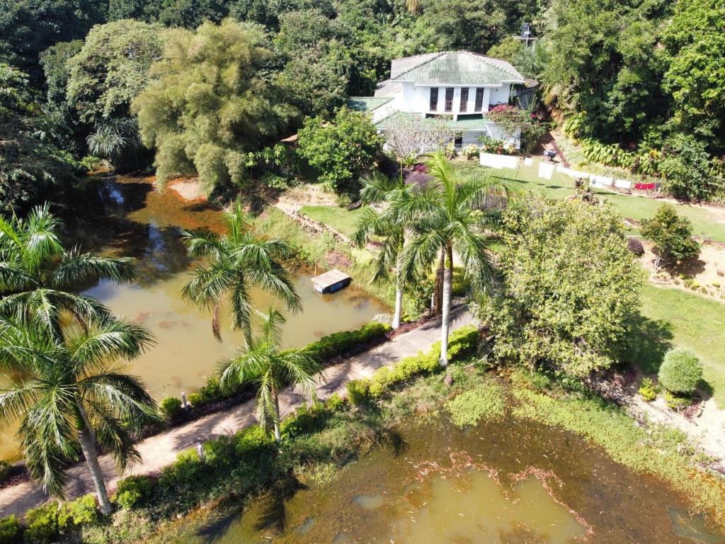 an aerial view of a house with a pool of water at Madikale Resort in Mirigama