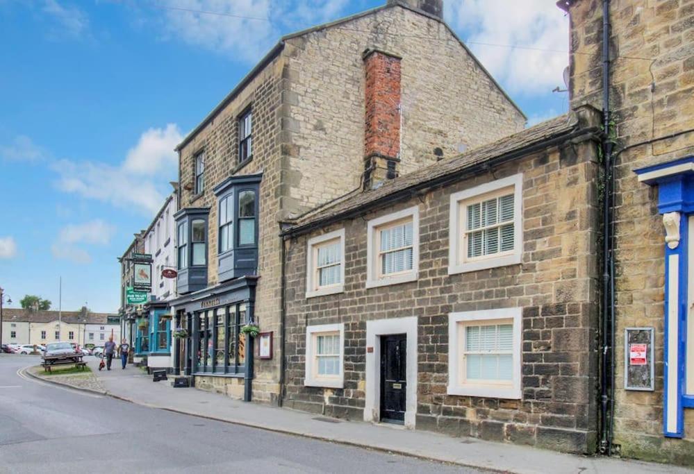 an old brick building on the side of a street at Lavender Cottage, Masham, Historic Listed, 2 bedrooms in Masham