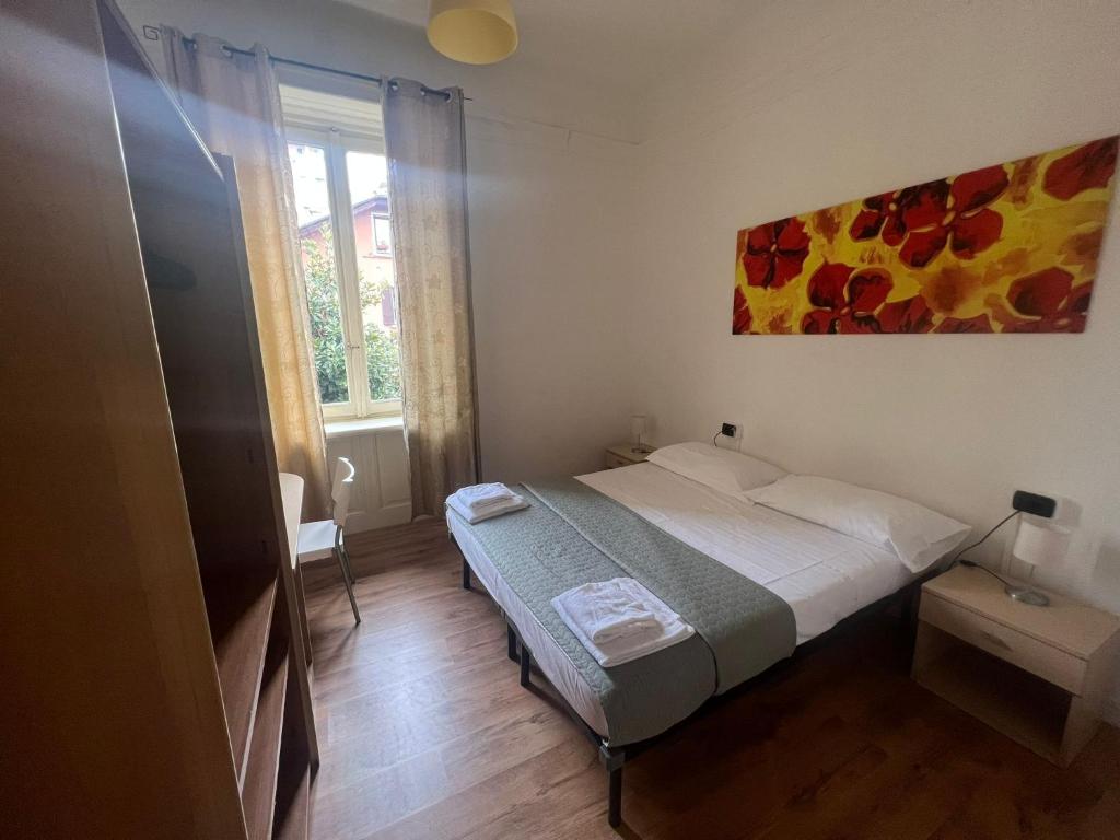 a bedroom with a bed and a painting on the wall at Ambra Boutique Hotel in Milan