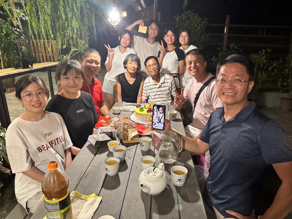 a group of people posing for a picture at a picnic table at Follow Me designed B&amp;B in Dongshan