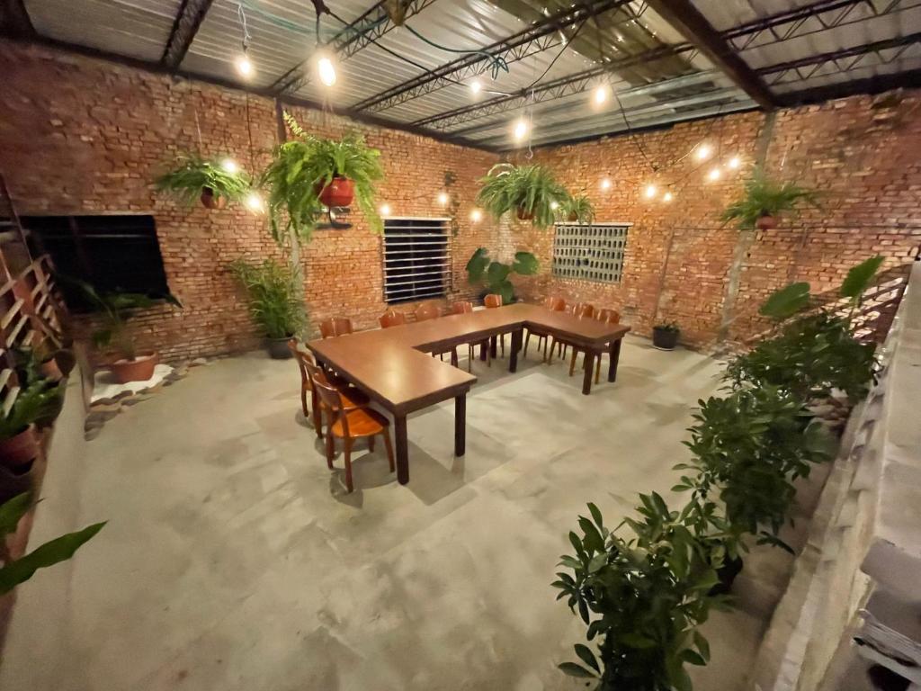 a room with a table and chairs and a brick wall at Follow Me designed B&amp;B in Dongshan