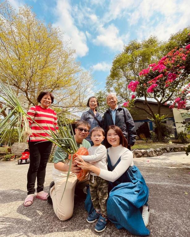 a group of people posing for a picture with a plant at Follow Me designed B&amp;B in Dongshan