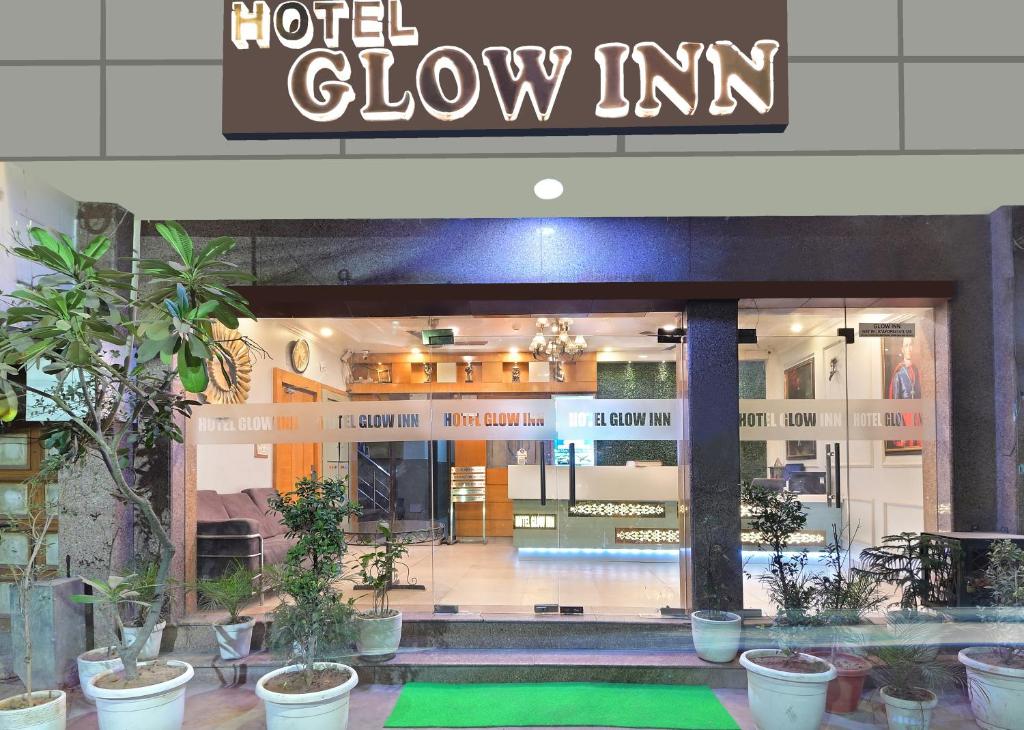 a hotel show inn with potted plants in front of it at Hotel Glow Inn Paharganj-3 Mins Walk From New Delhi Railway Station in New Delhi