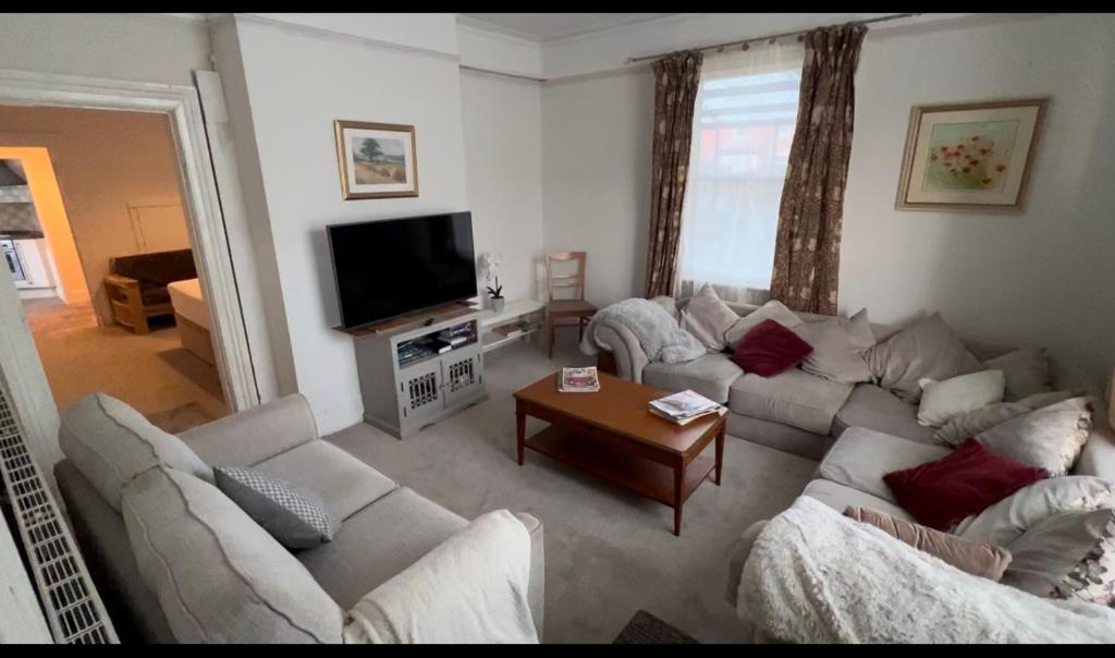 a living room with two couches and a television at Hollies House in Retford