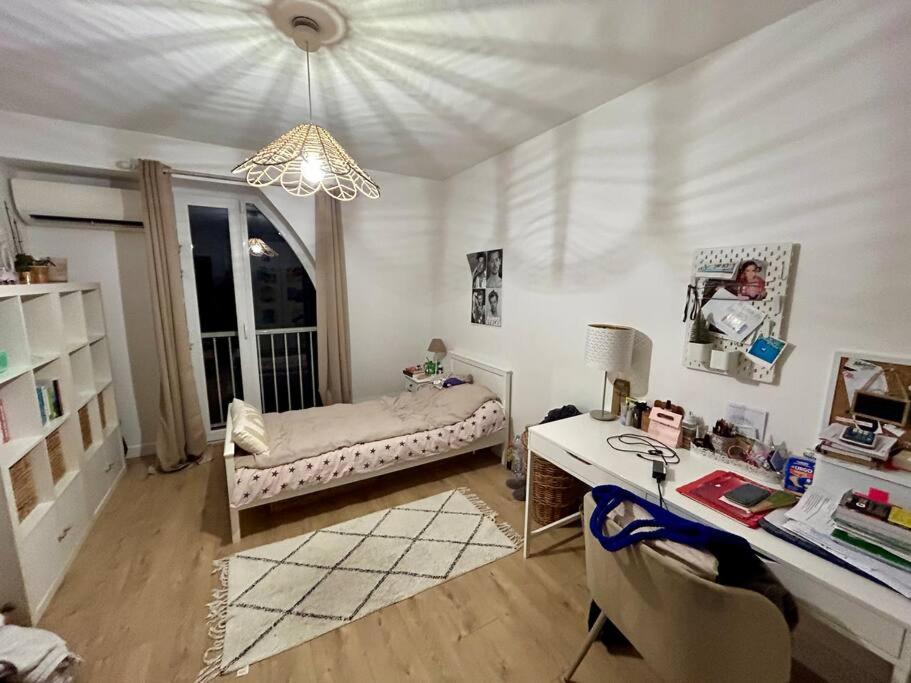 a room with a desk and a bed and a table and a deskablish at Maison climatisée 155 m2+jardin in Puteaux