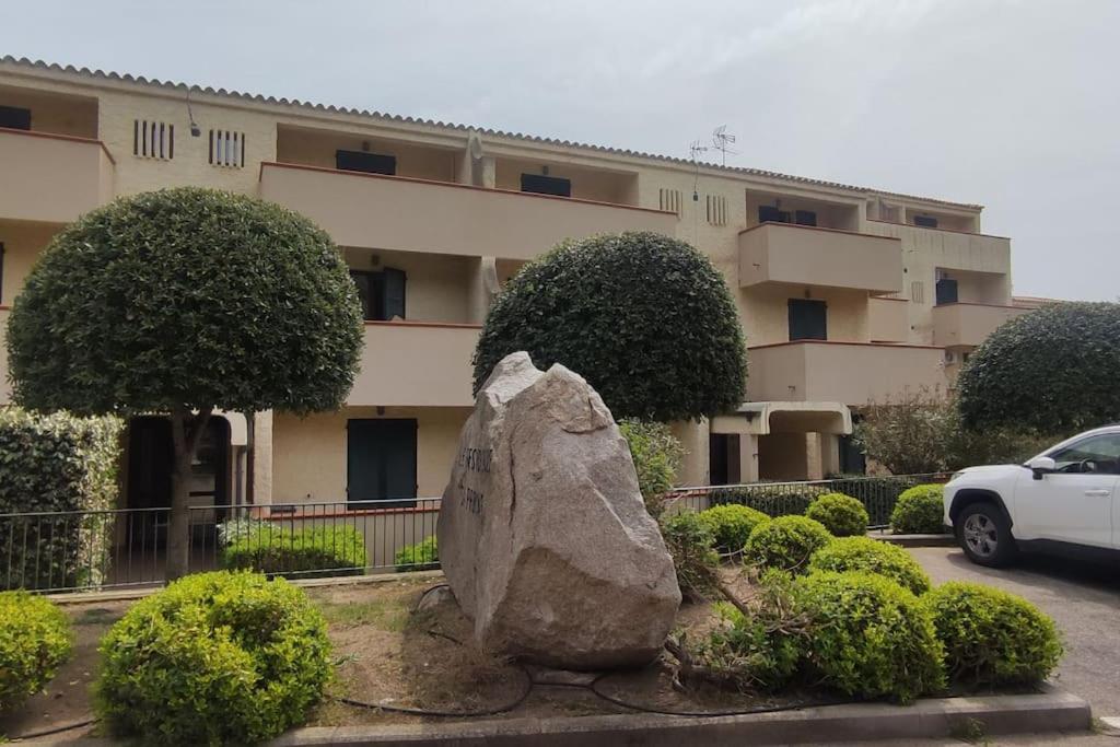 a large rock sitting in front of a building at Casa BLU B7 4 in La Maddalena