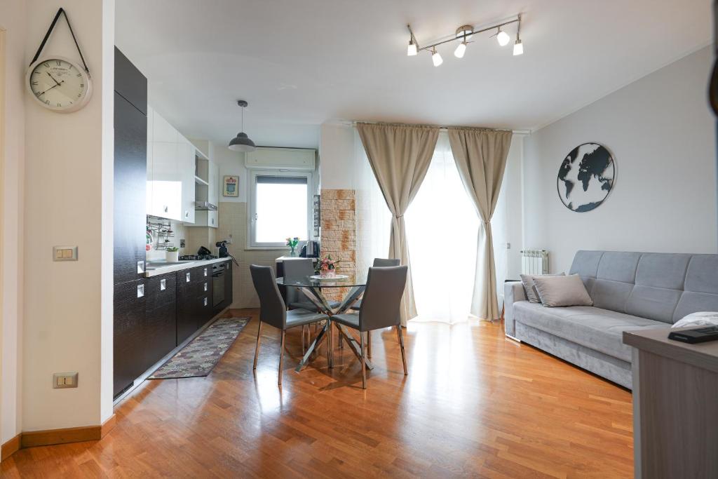 a living room with a couch and a table at Nuvola Apartment Fiumicino Easy Self check-in in Fiumicino