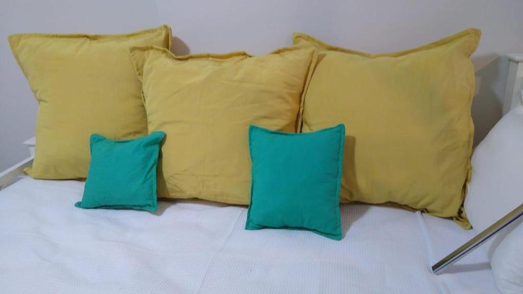 a group of four pillows on a bed at Palermo Embassy in Buenos Aires