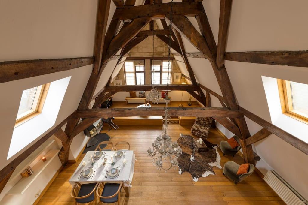 an overhead view of a room with wooden floors and windows at Chic Penthouse Grand-Place in Brussels