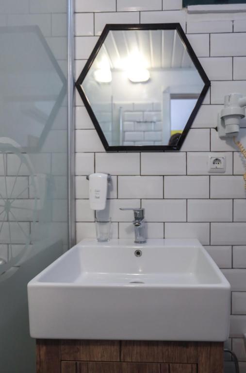 a white sink in a bathroom with a mirror at Limon Inn Hotel, Taşucu in Tasucu