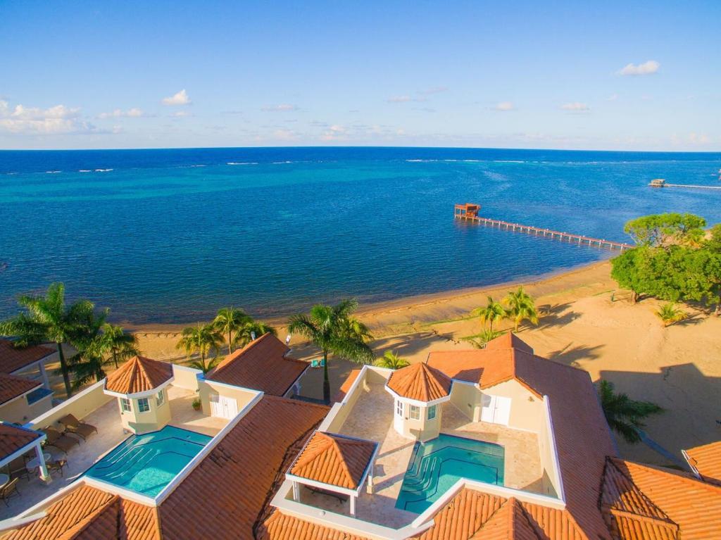 an aerial view of a house and the ocean at Lawson Rock - Angelfish 201 condo in Roatan