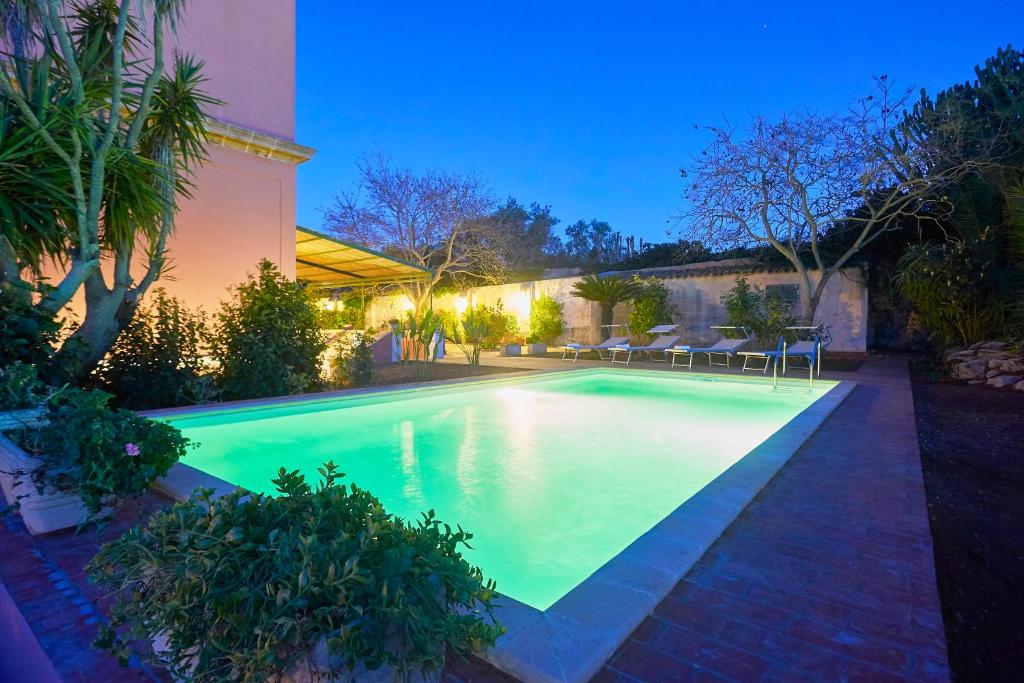 a swimming pool in the backyard of a house at Villa Maria in Marsala