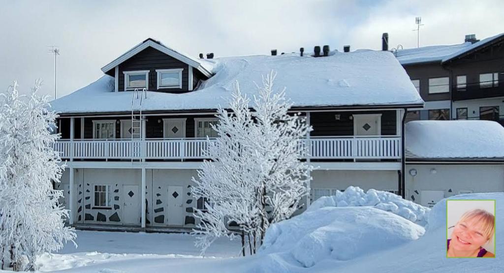 une maison recouverte de neige avec des arbres enneigés dans l'établissement Ylläs slope SareStar, à Ylläsjärvi