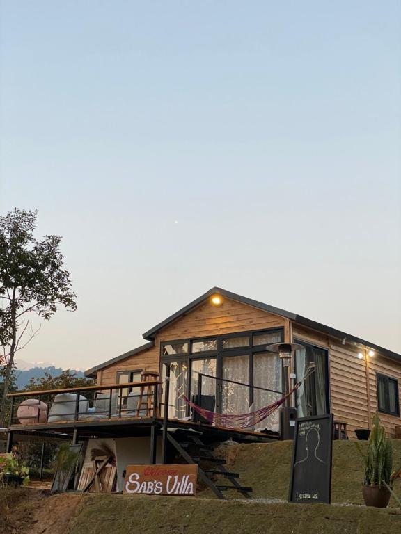 a house with a large deck on the side of it at (Sab’s villa )Forest cabin in Pokhara