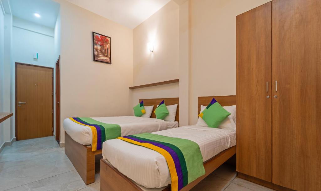 Postel nebo postele na pokoji v ubytování Itsy Hotels Avani Stays, Vyttila, Kochi