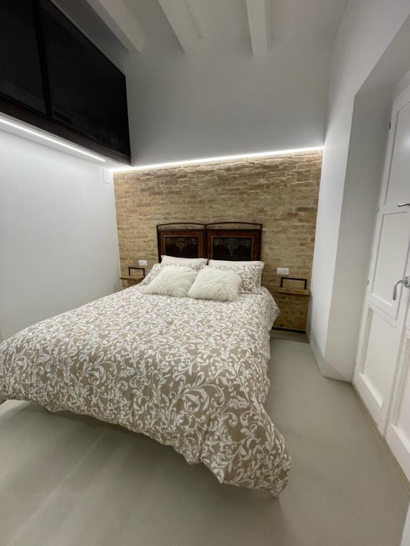 a bedroom with a bed with a comforter and a television at Al Civico 2 in Atri