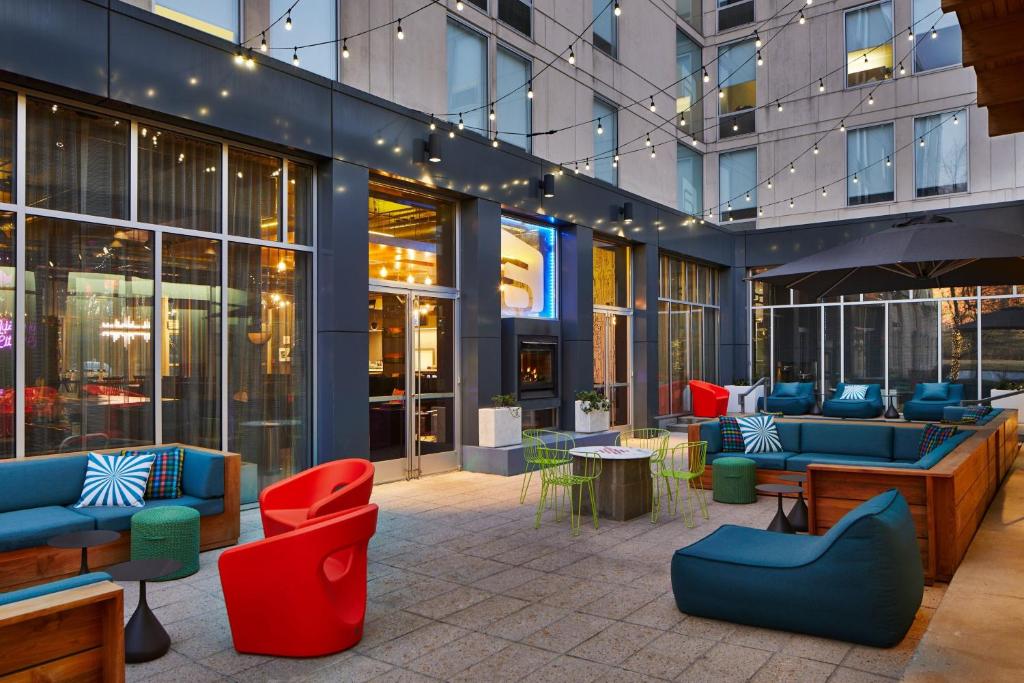a lobby of a building with blue and red furniture at Aloft Nashville Franklin in Franklin