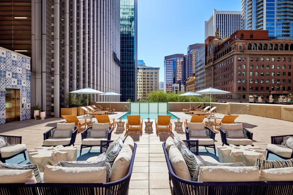 un patio en la azotea con sillas y mesas en un edificio en The Westin Phoenix Downtown en Phoenix