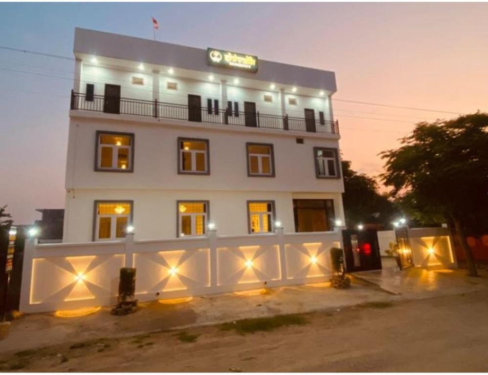a large white building with lights in front of it at Shivalik Residency, Obaree, UP in Bāra Banki