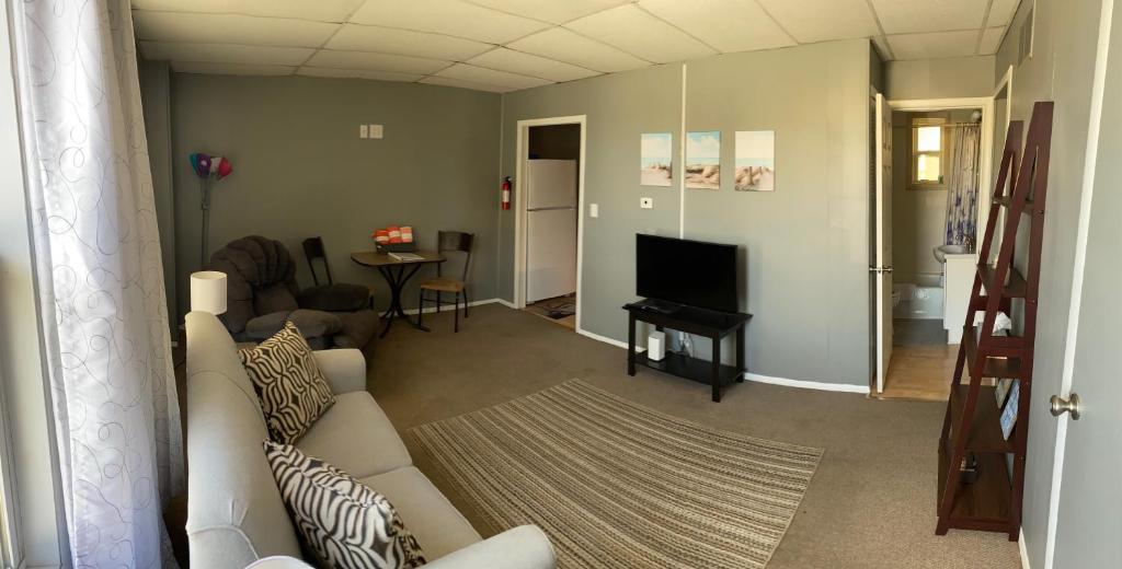 a living room with a couch and a television at Downtown Getaway in Michigan City