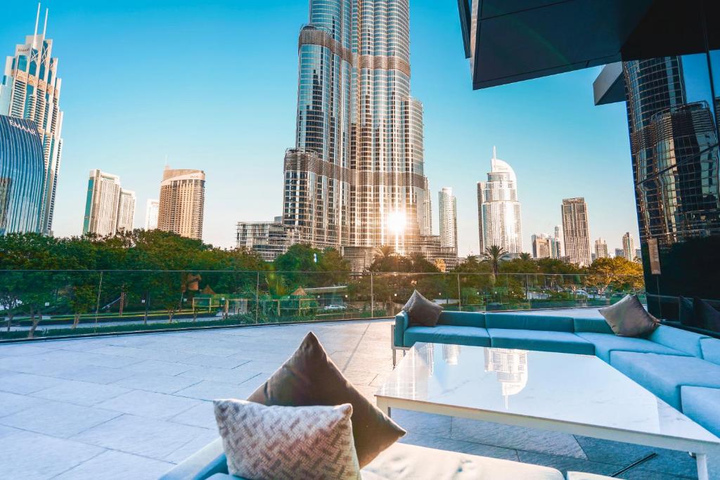 a rooftop patio with a view of a city skyline at THE CLOSEST building to Burj Khalifa with Fountain View in Address Opera Residence in Dubai