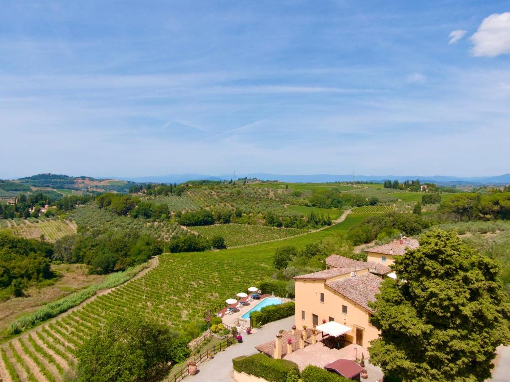 - une vue aérienne sur une maison et un vignoble dans l'établissement Podere Vergianoni con piscina e vista mozzafiato, à Tavarnelle in Val di Pesa