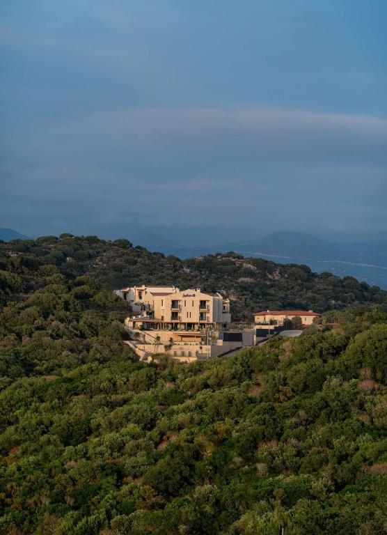 a house on top of a hill with trees at Radisson Blu Hotel, Kas in Kaş