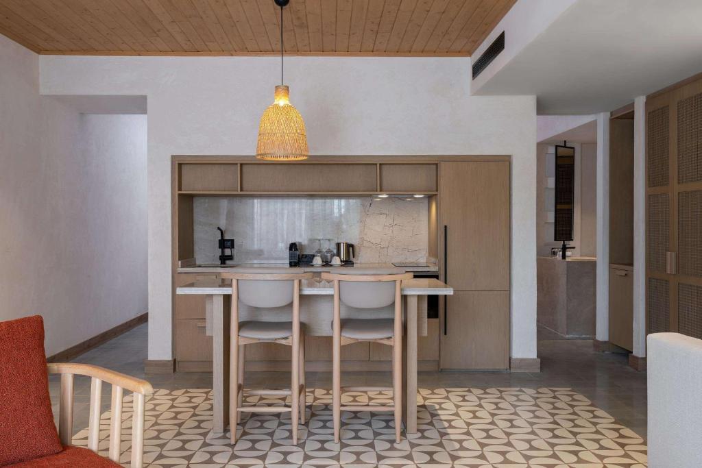 a kitchen with a table and chairs in a room at Radisson Blu Hotel, Kas in Kaş