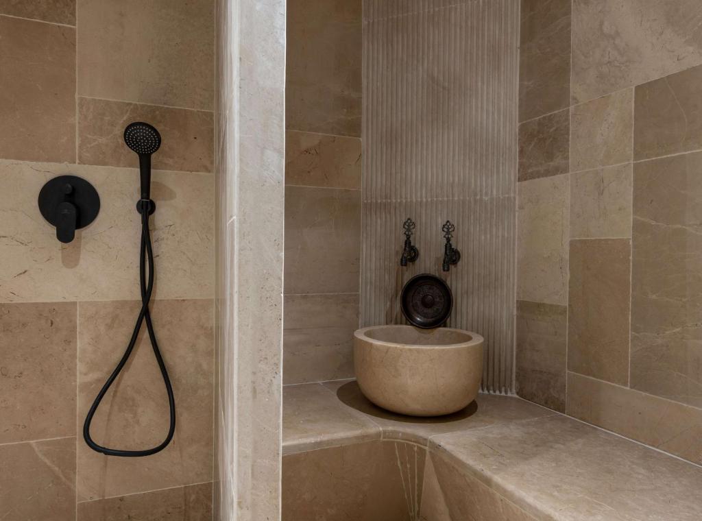 a bathroom with a shower with a sink in it at Radisson Blu Hotel, Kas in Kaş