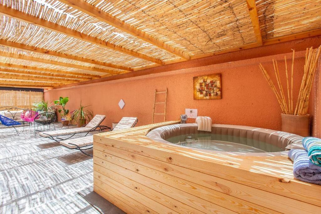 a large jacuzzi tub in a room with chairs at House with Hot Tub Private - Close to Hivernage District in Marrakesh