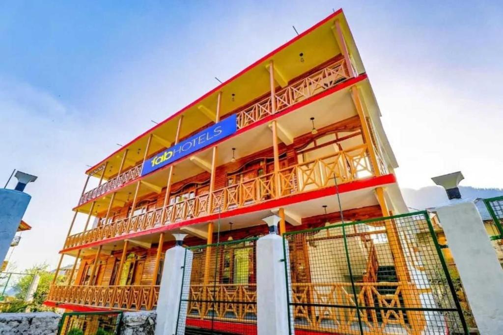 a building with a fence in front of it at Forest Retreat in Manāli