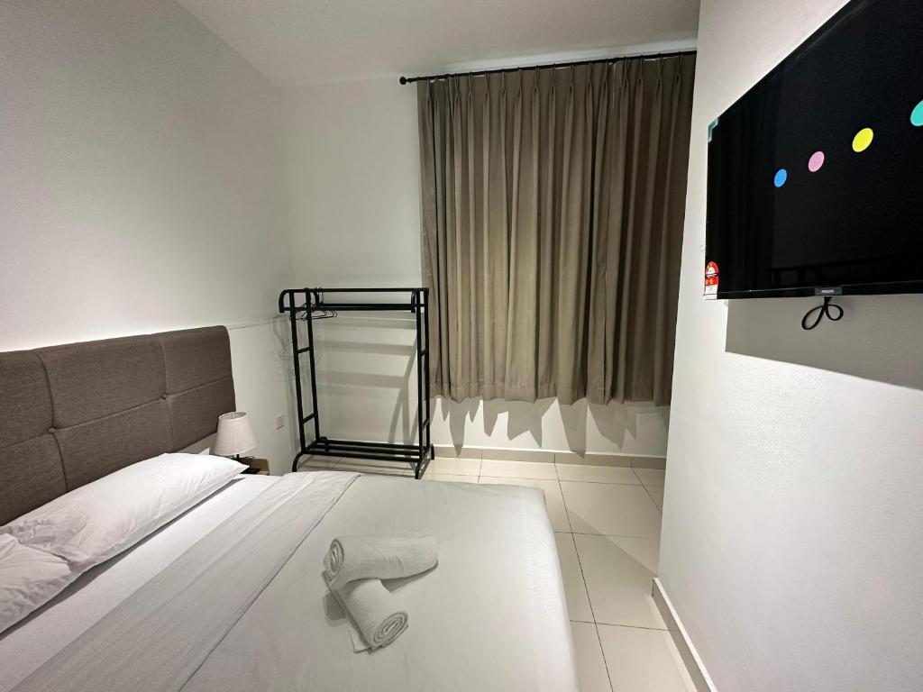 a bedroom with a bed and a flat screen tv at Lodge 43 House in George Town
