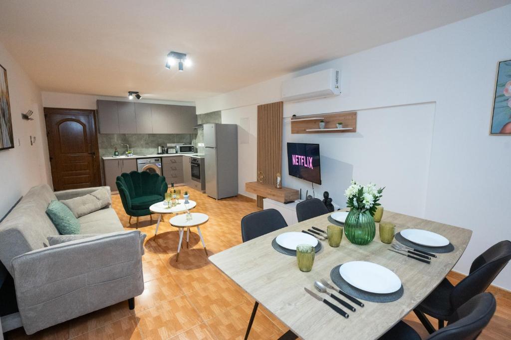 a living room with a table and a couch at Napa Centrale Suites in Ayia Napa