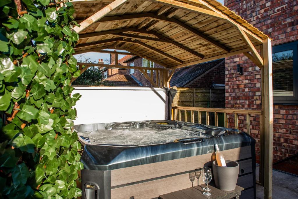 a jacuzzi tub in a gazebo at Balmoral House in Timperley