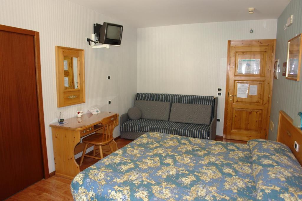 Postel nebo postele na pokoji v ubytování Hotel Club Funivia