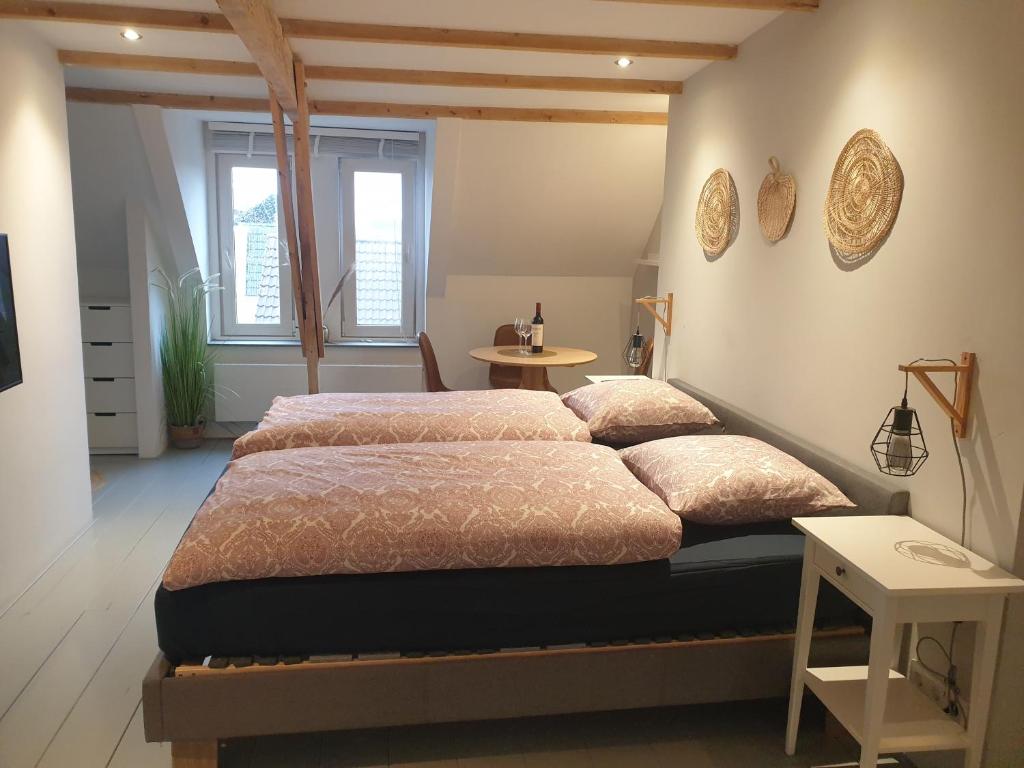 a bedroom with a large bed and a table at @Salland in Zwolle