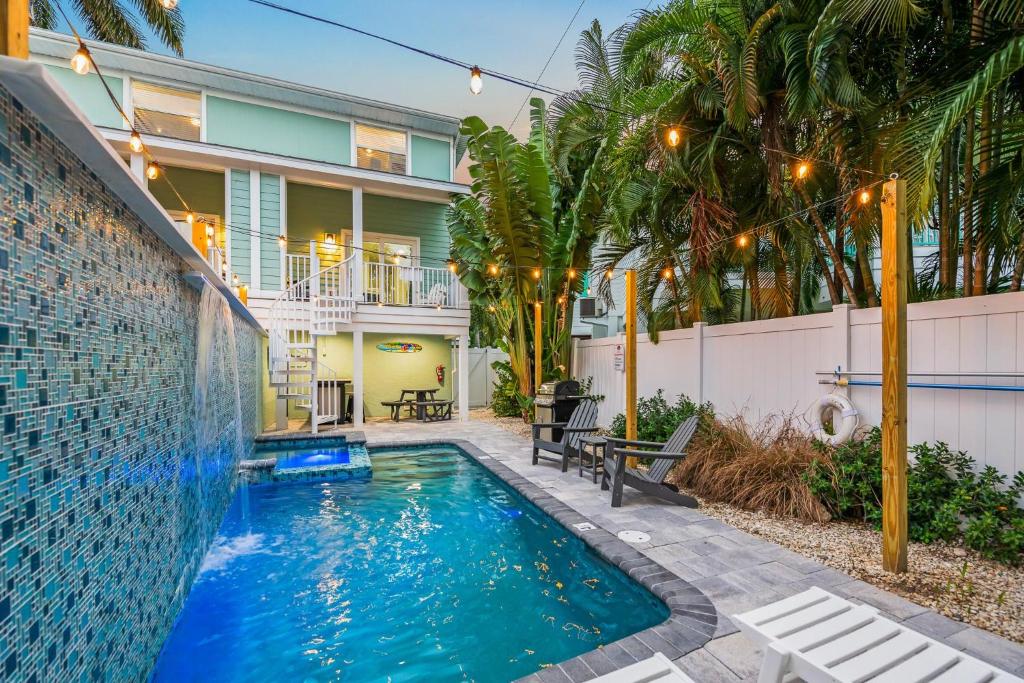 a swimming pool in front of a house at Island Time West in Siesta Key