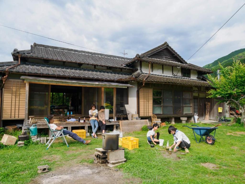 a group of people playing in a yard in front of a house at 竜野園藝 in Kamimashiki
