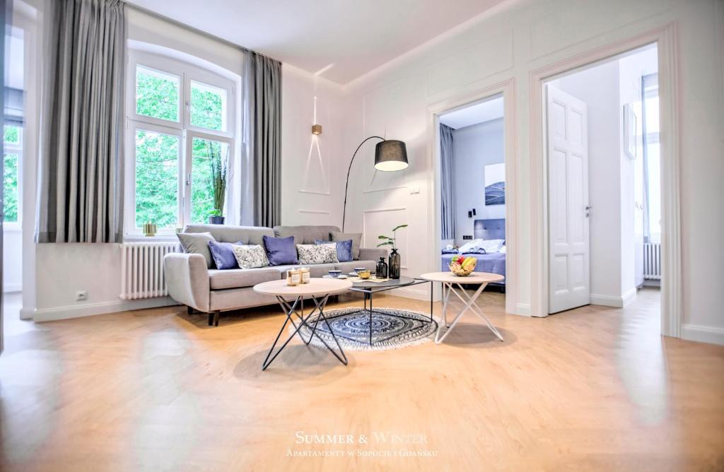 a living room with a couch and a table at Family Luxury Wonder Heaven Apartment, 50m to M Cassino, first with 3 badrooms&studio, second with 2 badrooms&studio, parking w cenie in Sopot