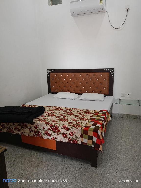 a bedroom with a bed with a quilt on it at Shri radhe shyam sadan in Govardhan